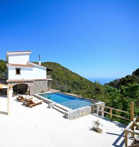 a villa with a swimming pool and a house at Villa Krio Pigadi in Kechria