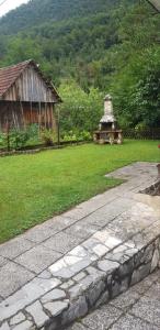 a garden with a stone walkway and a building at Apartma Sabatuš in Bohinj