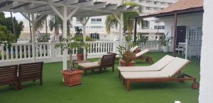 a patio with chairs and tables on a balcony at Villa las Flores in Adeje