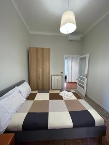 a bedroom with a large bed with a checkered floor at Piazza Vescovio Apartment in Rome