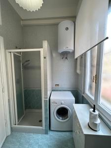 a laundry room with a washing machine and a shower at Piazza Vescovio Apartment in Rome