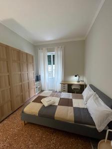 a bedroom with a bed and a desk and a window at Piazza Vescovio Apartment in Rome