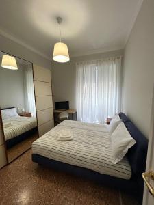 a bedroom with a large bed and a mirror at Piazza Vescovio Apartment in Rome