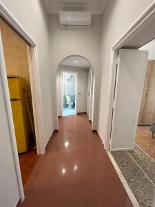 an empty hallway with a tile floor in a building at Piazza Vescovio Apartment in Rome