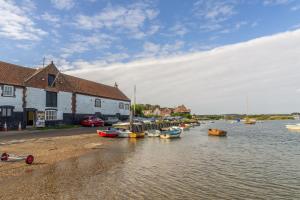 a group of boats are docked in a body of water at The Barn in Burnham Market