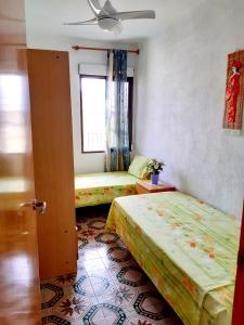a room with two beds and a window at Apartamento Vernissa in Gandía