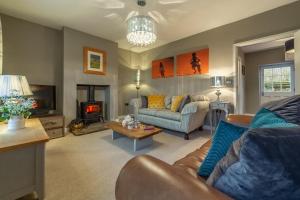 a living room with a couch and a fireplace at 2 Dix Cottages in Thornham