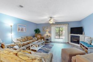 a living room with a couch and a fireplace at Gulf Highlands Grande Island Blvd in Panama City Beach