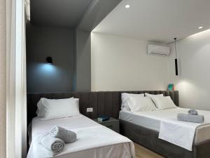 two beds sitting next to each other in a room at Luxurious seaside apartment in Durrës +11 photos