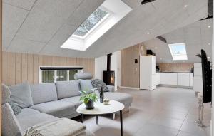 a living room with a couch and a table at Holiday Home Bjergbovej Blåvand Denm in Blåvand