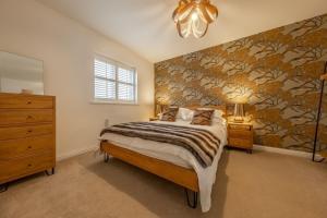 a bedroom with a bed and a wall mural at Lavandula 6 in Burnham Market