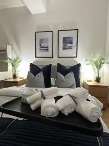 a bedroom with a bed with towels on it at Retreat to a Stylish Ensuite in London in London