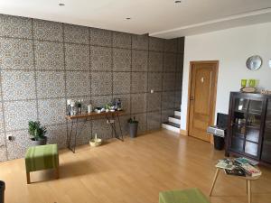 a living room with a wooden floor and a wall at KAZARÃO DI MAVETE- Guesthouse in Praia