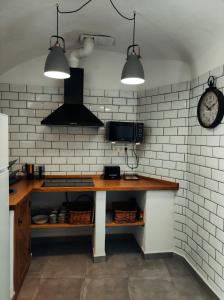 uma cozinha com uma mesa e um relógio na parede em La Madriguera Eco Caves 3 em Guadix