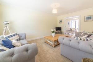 a living room with two couches and a coffee table at Taureans in Wells next the Sea