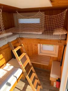 an overhead view of a bunk bed and ladder in a cabin at Tiny House Lodge Dresden in Dresden