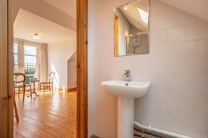 a bathroom with a sink and a mirror on the wall at Gallery Cottage in Wighton +28 photos