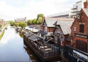 a view of a river with a building next to it at Stylish 1 Bedroom, 2 bed Basement Flat With Free Parking in Sale