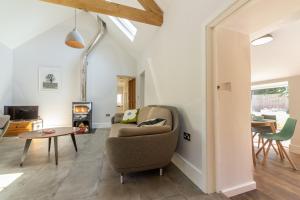 a living room with a couch and a table at The Nurseries in Syderstone