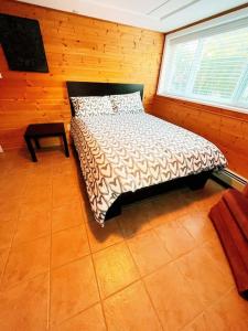 a bedroom with a bed in a room with a window at Riverside Harrison Hotsprings House in Harrison Hot Springs