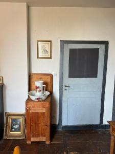 una habitación con una puerta blanca y un plato en una mesa en Le Loriot, en Champagne-et-Fontaine