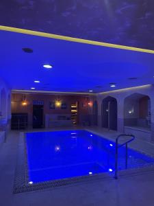 a large swimming pool with a blue ceiling at Hotel Palladium in Odesa