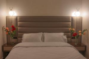 Postel nebo postele na pokoji v ubytování Hôtel Des Lilas
