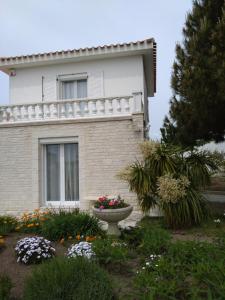 a house with a flower garden in front of it at Maison avec Jardin privé in Saint-Hilaire-de-Riez