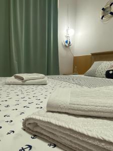 a bedroom with two beds with towels on them at ANI Apartment in Ohrid
