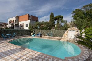 a swimming pool in front of a house at Casa Romana in Tor Vergata