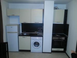 a kitchen with a washing machine and a washer at Apartment Nova in Burgas