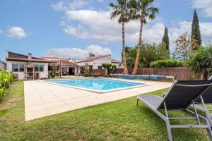 a backyard with a swimming pool and a house at Rustic Retreat in Algoz in Algoz