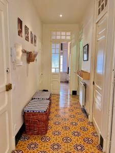 a hallway with a floor with a bench on it at Apartamento Tramuntana de Portbou in Portbou