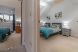 a bedroom with a bed with a blue comforter at The Moorings in Wells next the Sea