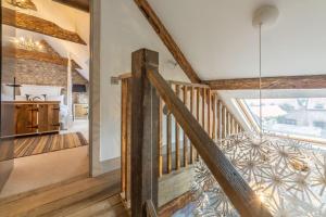 a wooden staircase in a home with a vaulted ceilings at Hideaway Barn 4 in Thornham