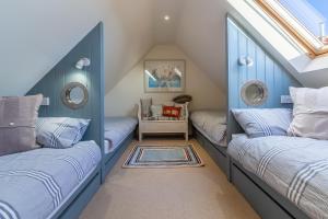 a attic room with two beds and a skylight at The Little Barn in Ringstead