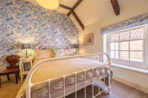 En eller flere senge i et værelse på Arch Cottage