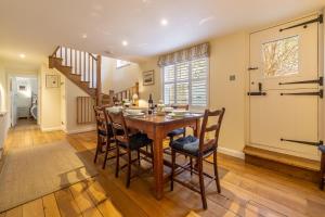 a dining room with a wooden table and chairs at Sea Holly House in Blakeney