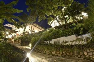 a garden with a water fountain in front of a house at Ling & Louie's Mountain in Mayong