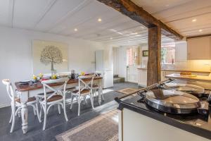 a kitchen with a table and chairs and a stove at The Tack House in Holkham