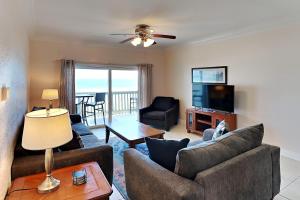 a living room with two couches and a television at Villas on the Gulf #N1 in Pensacola Beach