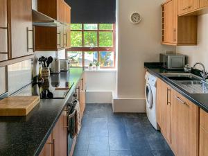 a kitchen with a sink and a dishwasher at Mill Court in Dunblane