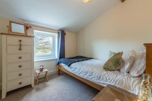 a small bedroom with a bed and a window at 2 Providence Place in Thornage