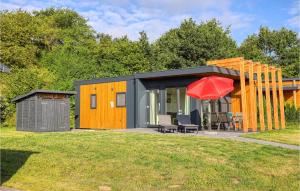 a black and orange tiny house with a red umbrella at Sonnenschein in Süsel