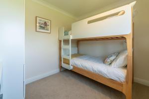 a small bedroom with bunk beds in a house at Stone Croft in Barney