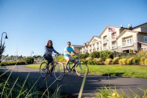 a man and woman riding bikes down a street at Hotel Bellwether on Bellingham Bay in Bellingham