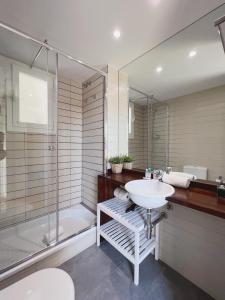 a bathroom with a white sink and a shower at Stay U-nique Apartments Sants II in Barcelona