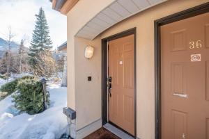 a door to a house in the snow at Lagoons by Outpost Whistler in Whistler