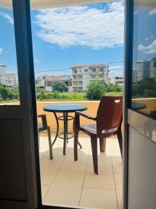 a table and chair on a balcony with a table and a view at Apartments Betti in Ulcinj