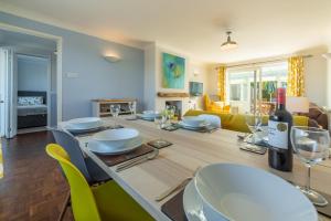 a living room with a table with wine glasses at High View in Wells next the Sea